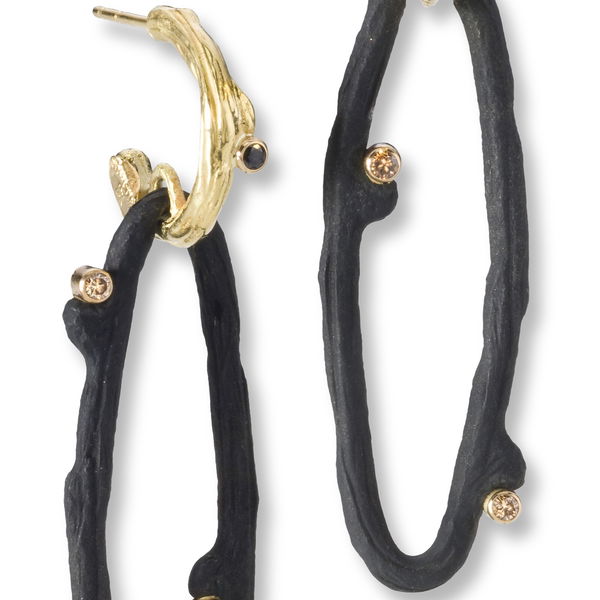 Closeup photo of Hemp Oval Dangle Hoop Earrings with White Diamonds in in Black Chrome and 18kt Yellow Gold