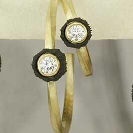 Closeup photo of Twist 20mm Double Hoop Earrings with White Diamonds in Black Chrome and 18kt Yellow Gold