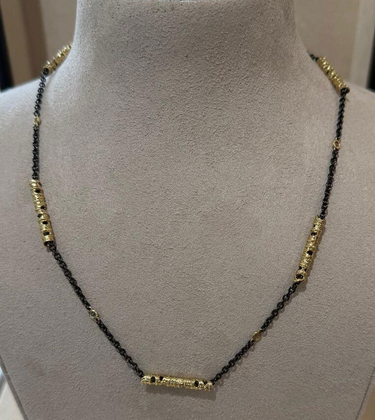 Aspen Station Necklace with White Diamonds in 18kt Yellow Gold and Sterling Silver by Sarah Graham. Five 18kt yellow gold Aspen motif stations with white diamond stations in between on an oxidized sterling silver chain of 18 inches long. There are 0.20ctw of white diamonds in the necklace. Aspen Station Necklace with White Diamonds in 18kt Yellow Gold and Sterling Silver