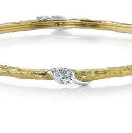 Closeup photo of Small Width Arbor Bangle Bracelet with 6 Diamond Leaves in Burnished 19kt Yellow Gold