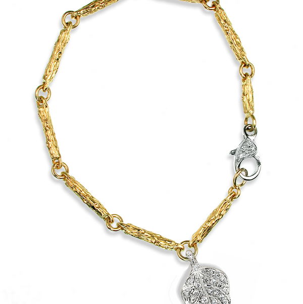 Closeup photo of Branch Link Bracelet with Diamond Leaf Charm in 18kt White Gold and 19kt Yellow Gold