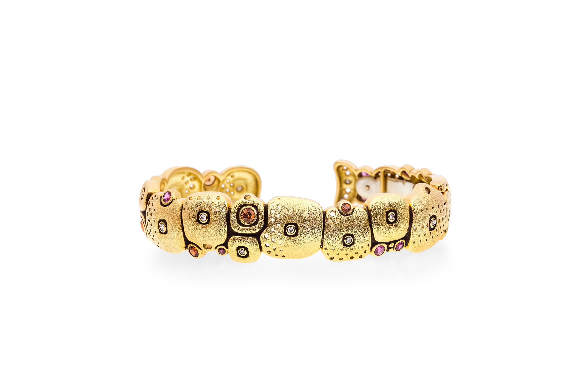 Little Orchard Cuff Bracelet with Pink and Orange Sapphires in 18kt Yellow Gold by Alex Sepkus. Narrow cuff bracelet with fourteen orange and pink sapphires at 1.19ctw and seventeen white diamonds at 0.21ctw. Bracelet is a hinged cuff bracelet and is the narrower of the two orchard cuffs. Gold is hand engraved and oxidized. Little Orchard Cuff Bracelet with Pink and Orange Sapphires in 18kt Yellow Gold