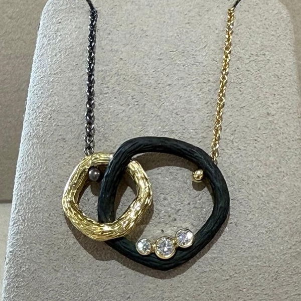 Pebble Medium Double Link Necklace with White Diamonds in Black Chrome, 18kt Yellow Gold and Silver Closeup photo of Pebble Medium Double Link Necklace with White Diamonds in Black Chrome, 18kt Yellow Gold and Silver