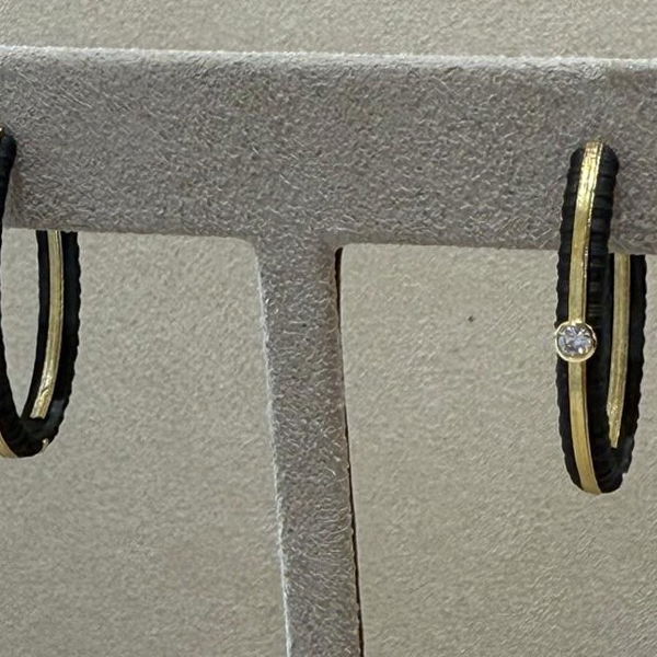 Closeup photo of Ridge 27mm Hinged Oval Inside Out Gold Strip Hoop Earrings with White Diamonds in Black Chrome and 18kt Yellow Gold