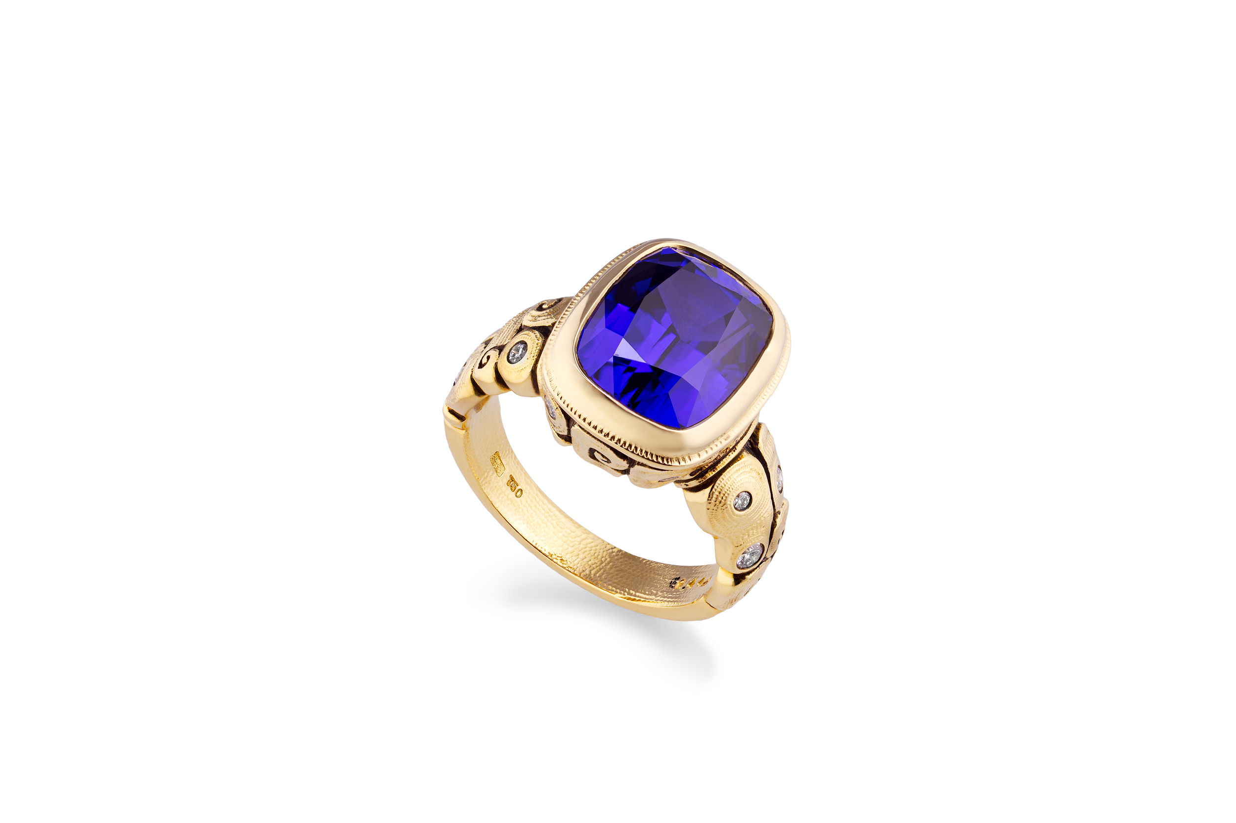 Seashell Ring with Tanzanite in 18kt Yellow Gold by Alex Sepkus - Bezel set cushion cut tanzanite center stone at 6.44ct and measuring 12.5mm by 9.3mm set in microscopically engraved and oxidized18kt yellow gold and accented with thirteen white diamonds at 0.21ctw. Seashell Ring with Tanzanite in 18kt Yellow Gold