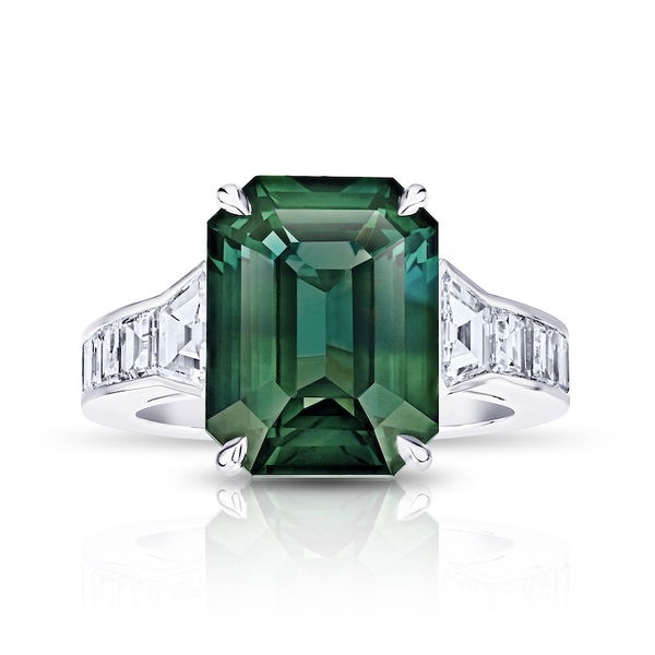 Closeup photo of Emerald Cut Green Sapphire Ring with Trapezoid Diamonds in Platinum Ring