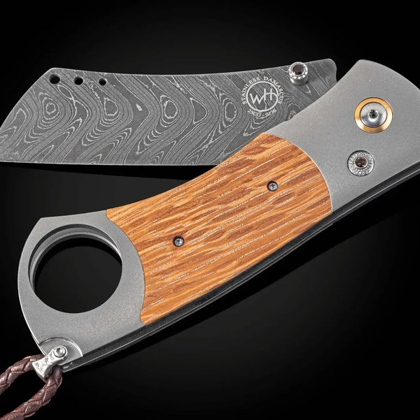 Closeup photo of CG1 RIP Titanium Cigar Cutter with Pappy Van Winkle Wood and Damascus Blade - 044/500