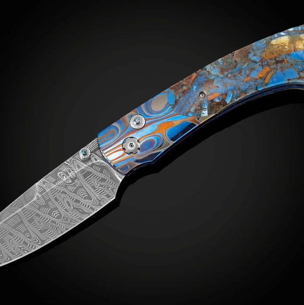 Closeup photo of B12 Blue Mosaic Pocketknife Featuring Fossil Woolly Mammoth Tusk and a Damascus Blade - 050/100