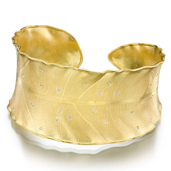 Closeup photo of Wide Leaf Cuff Bracelet with White Diamonds in 18kt Yellow Gold