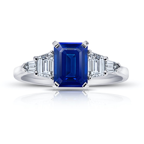 Closeup photo of Emerald Cut 2.25ct Blue Sapphire Ring with Trapezoid Diamonds in Platinum
