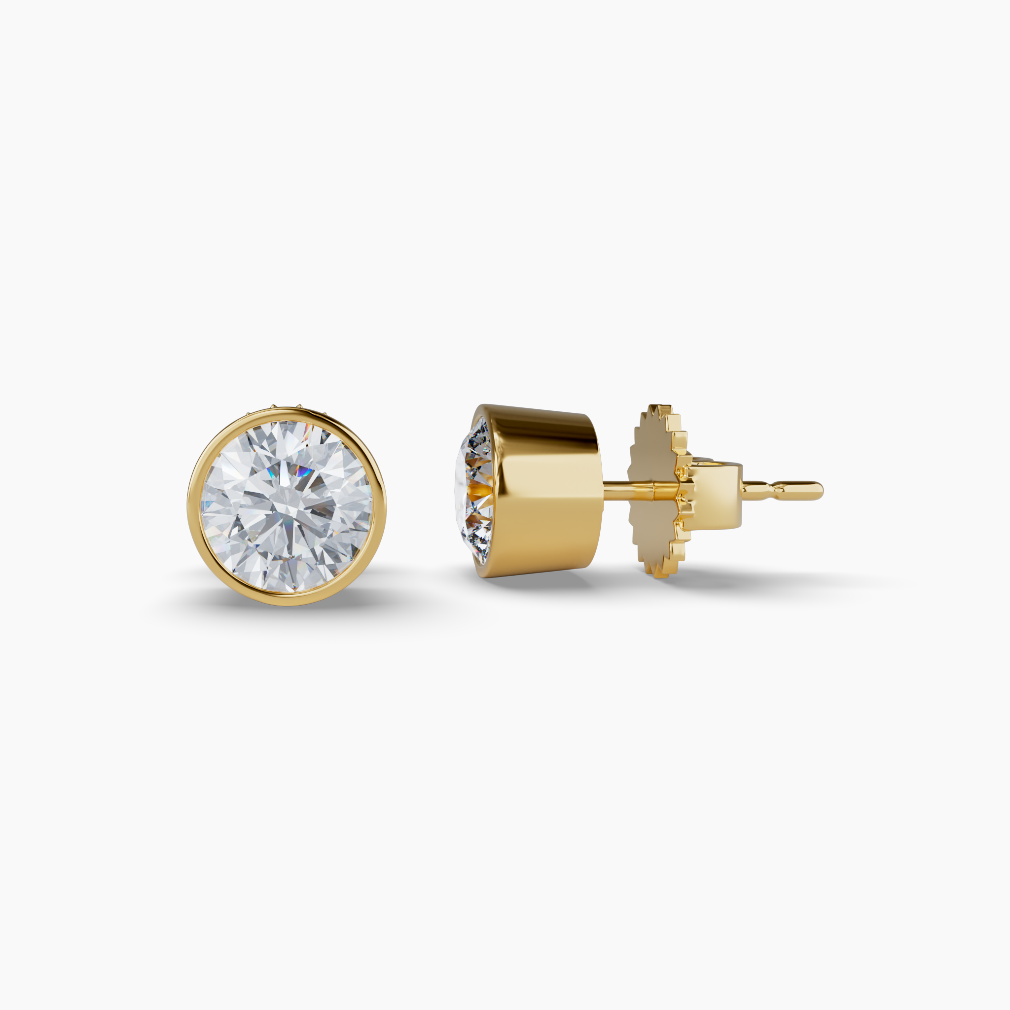 Featuring 2 total carats of lab-grown round diamonds, these earrings are set in sleek 14K recycled yellow gold with a modern bezel design. Sustainably crafted using wind and solar energy, the diamonds are 100% carbon-neutral. Diamond Essentials Lab Grown Round Bezel Studs (2CT), Yellow Gold