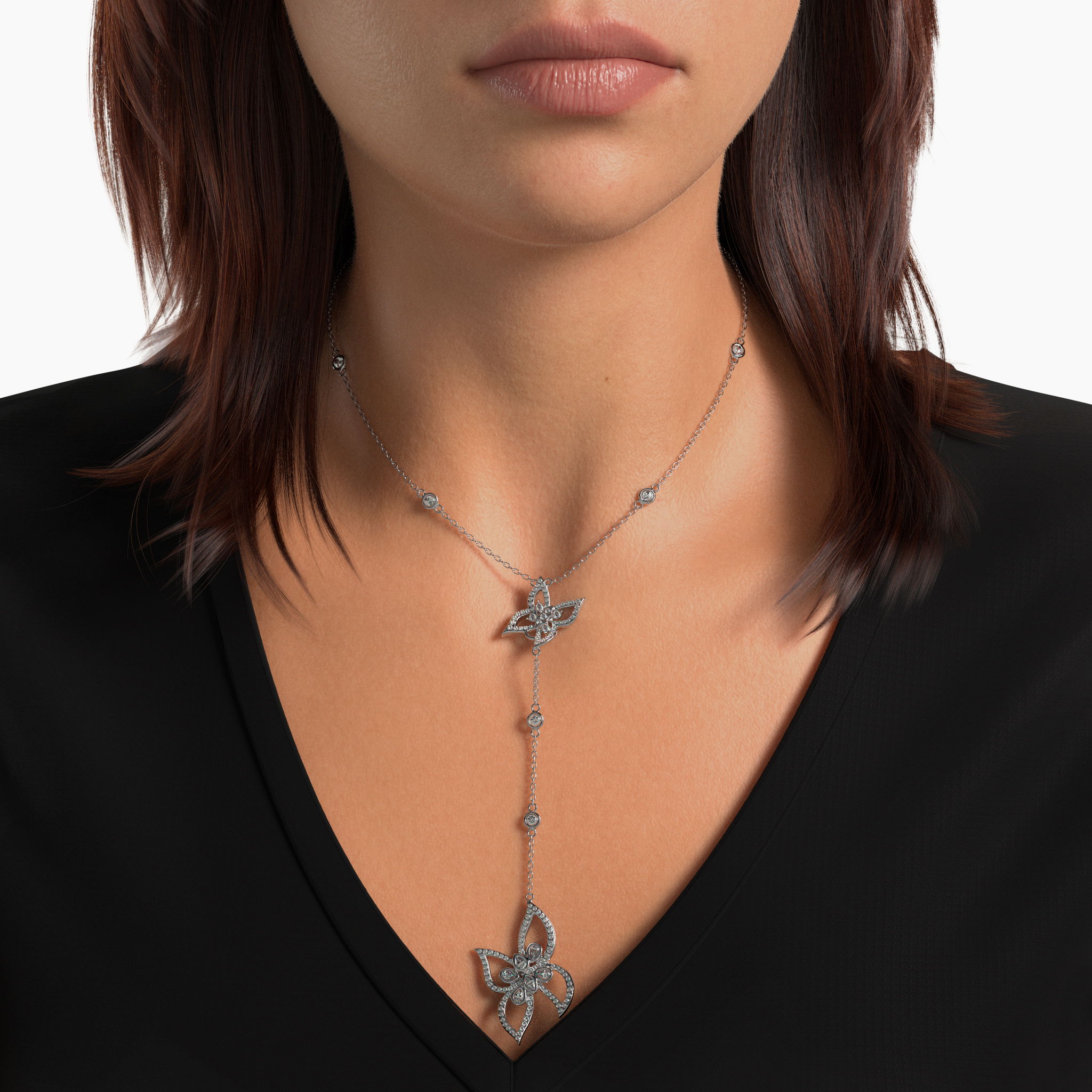 Discover the dazzling allure of the "Metamorphosis" lariat, exquisitely crafted from sterling silver and adorned with a butterfly centerpiece surrounded by 2 carats of diamonds distributed among 19 stones. This elegant necklace drapes beautifully, offering a luxurious and versatile statement piece that elevates any ensemble with its sparkling charm. Metamorphosis Diamond Butterfly Lariat
