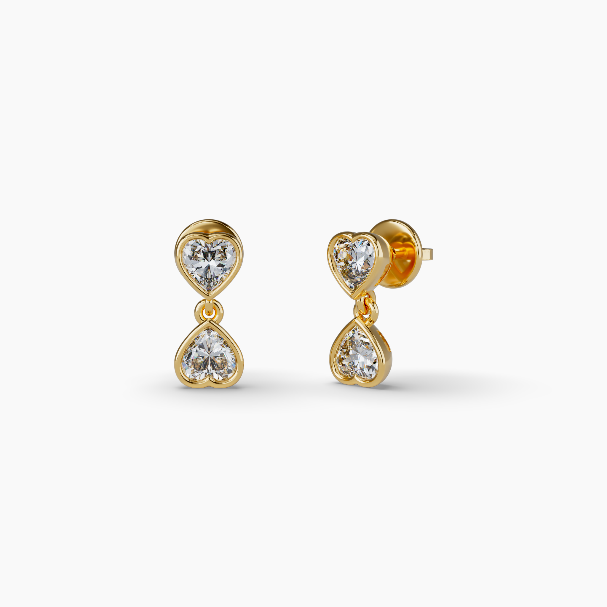 Radiate elegance with these romantic double heart-cut drop earrings. Featuring a total weight of 0.95 carats, these diamonds are lab-grown using wind and solar power, making them 100% carbon-neutral. These bezel set earrings are made in yellow vermeil, crafted with recycled sterling silver and coated with a thick later of 18 karat gold. Vermeil offers the elegance of gold at an attractive and accessible price point without sacrificing the beauty, warmth and radiance of karat gold. Adding a signature touch is a small purple lab grown diamond on the back of both earrings -- a hallmark of GRWN's dedication to sustainable craftsmanship. Bezel Set Hanging Heart Lab Diamond Earrings, Yellow Gold Vermeil