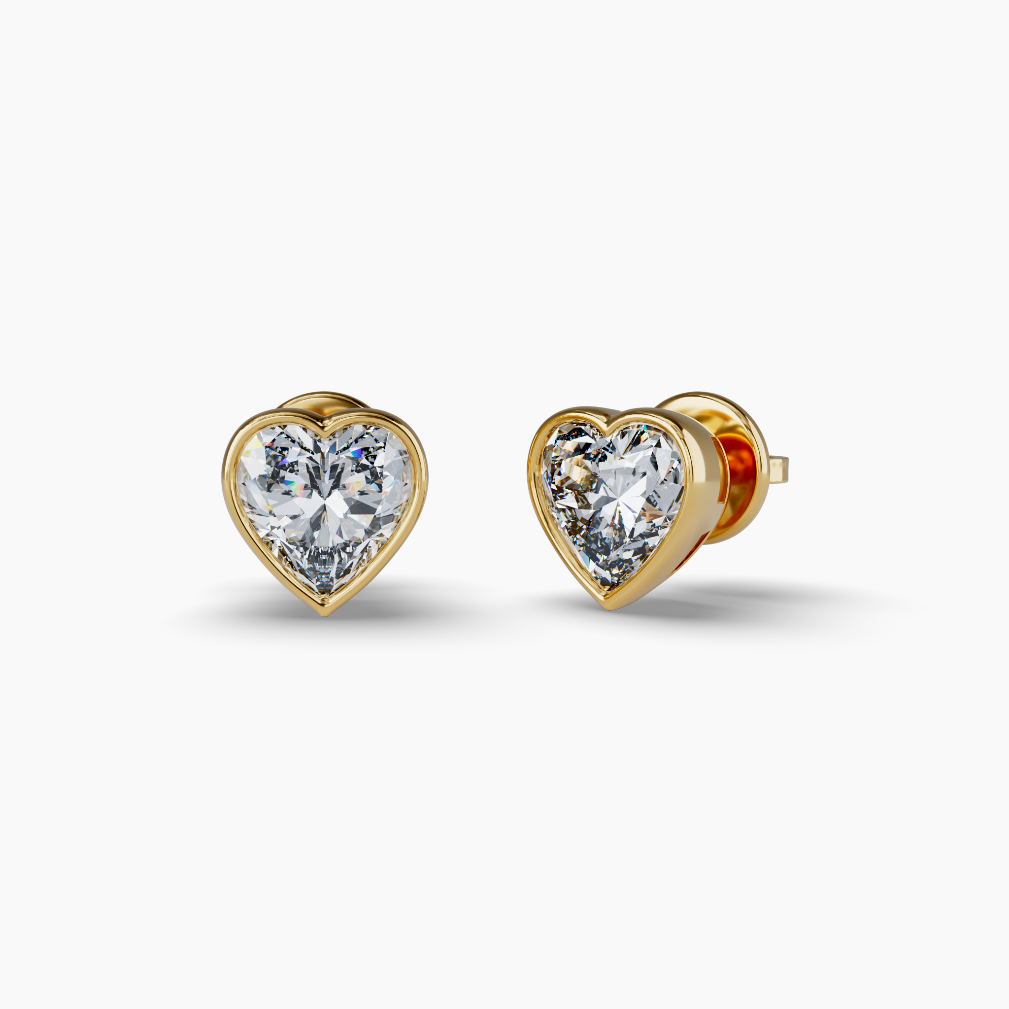 Material: 925 Sterling Silver, 18K Yellow Gold Vermeil Stones: 1.2ctw Heart-Shaped Carbon Neutral Lab-Grown Diamonds, F+ VS+Details: Signature Purple Lab Diamond on BackClosure: Secure Push BackSustainability: Lab-Grown with Wind and Solar Energy Bezel Set Heart Lab Diamond Stud Earrings, Yellow Gold Vermeil