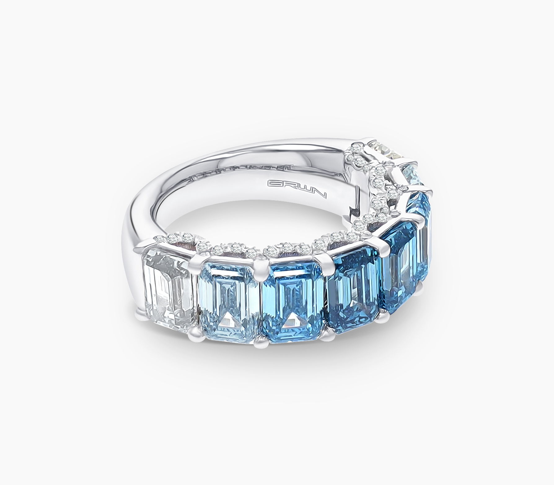 Material: 18K White Gold, White RhodiumDiamond(s): Blue and White Ombre Emerald Cuts and Round Pave, Carbon Neutral Lab-Grown Diamonds, VS+Total Carat Weight: 8.86ctwSize: 7Sustainability: Recycled Gold and Carbon Neutral Diamonds Grown by Wind and Solar Blue Ombré Lab Diamond Half Eternity Band