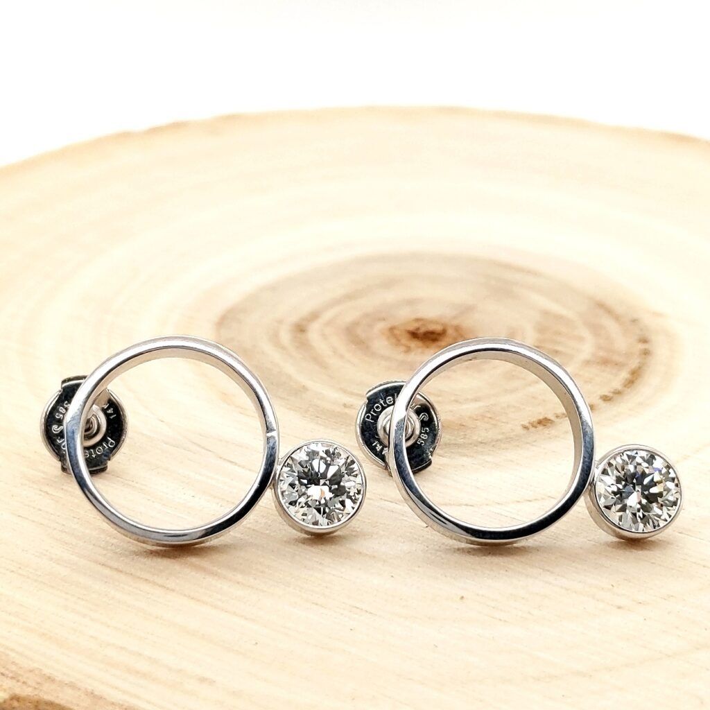 Diamond hoop earrings on natural wood