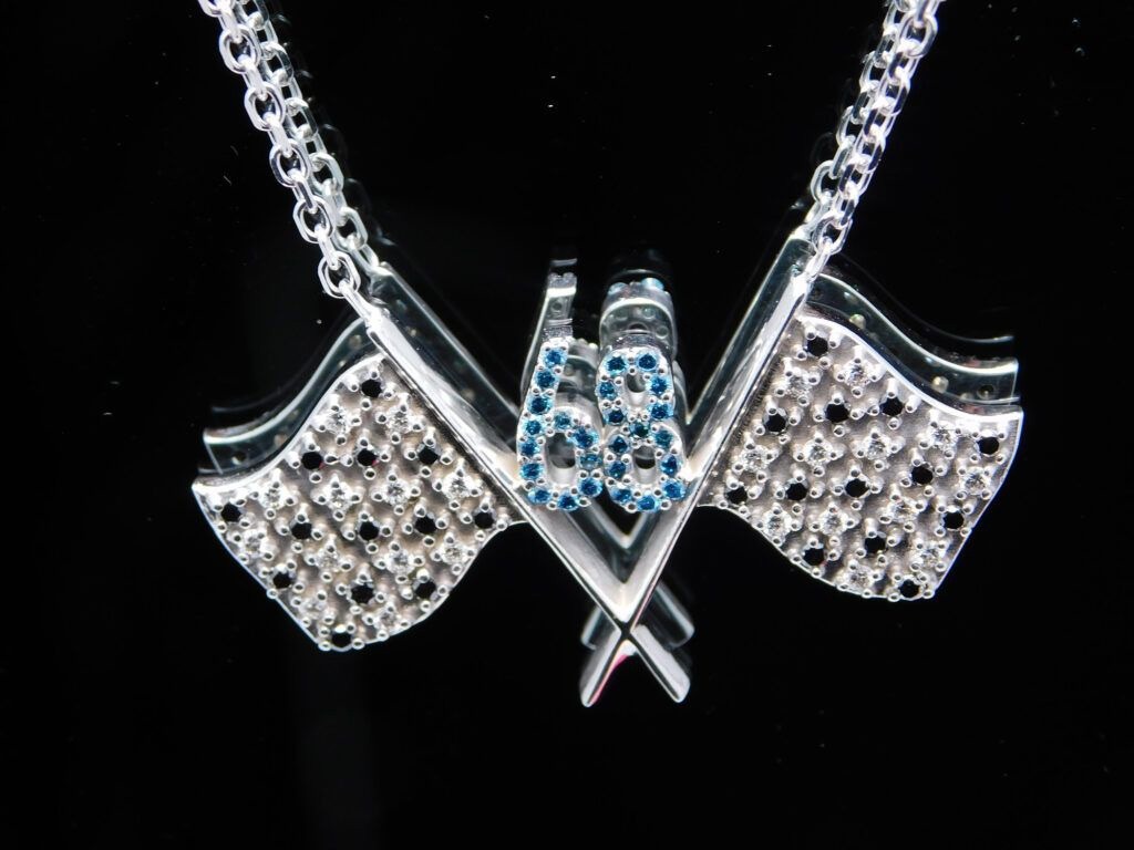 Diamond and blue topaz crossover pendant