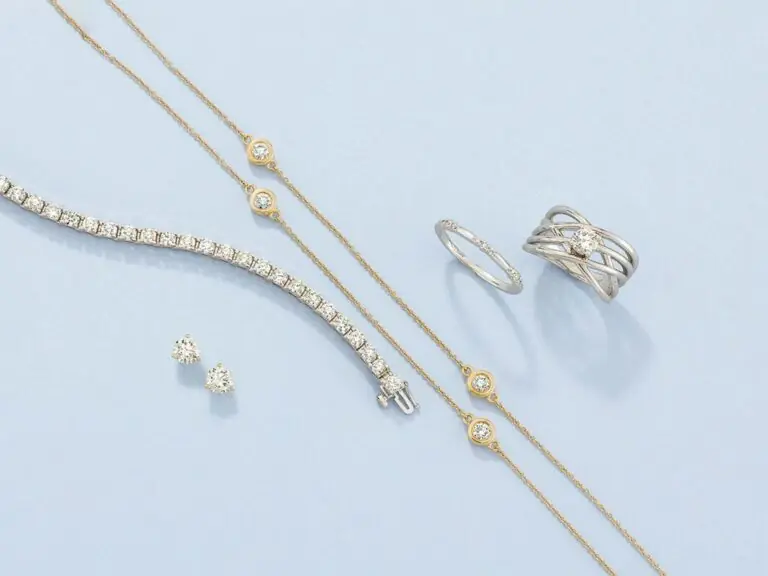Stuller diamond jewelry, bracelet, ring and earrings on a soft blue field
