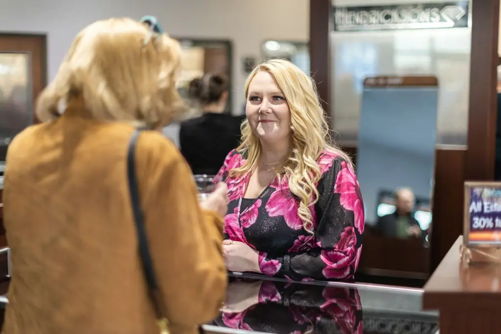 Warm interior of the jewelry store with a customer being helped at the counter