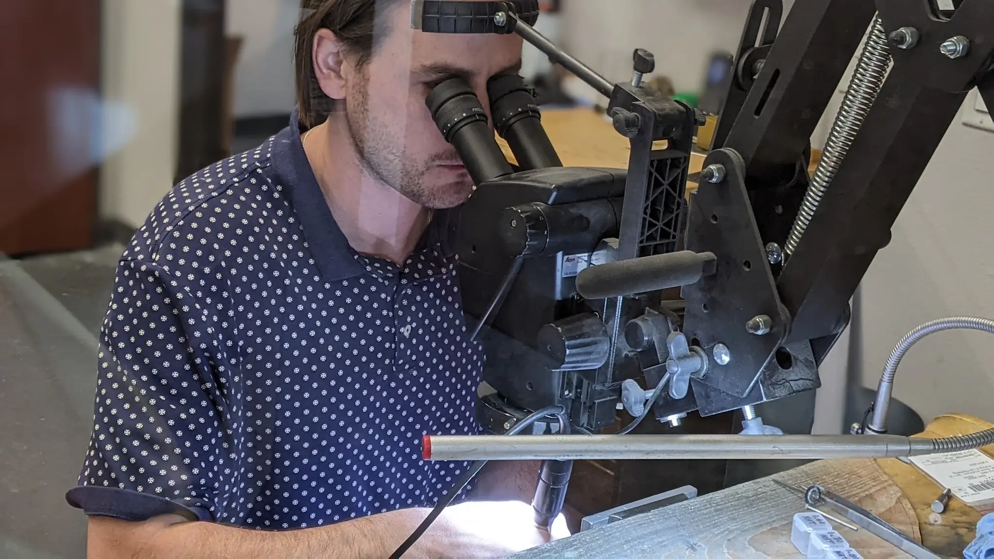 Jeweler using precision tools to set a stone into a gold ring