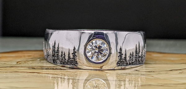 Rose gold band engraved with an intricate pattern