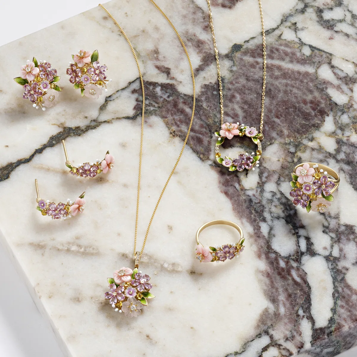 Enamel flower jewelry on purple-veined marble