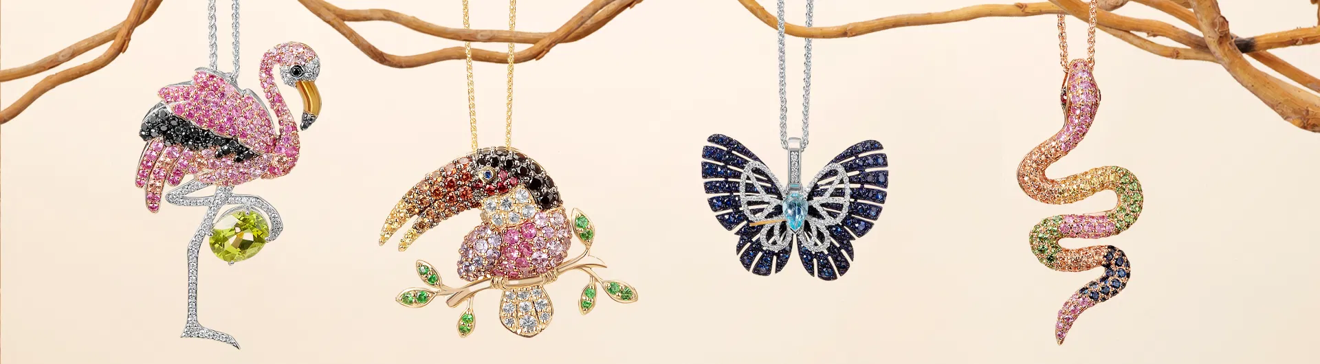 Gold jewelry with wildlife-inspired motifs displayed on dark velvet