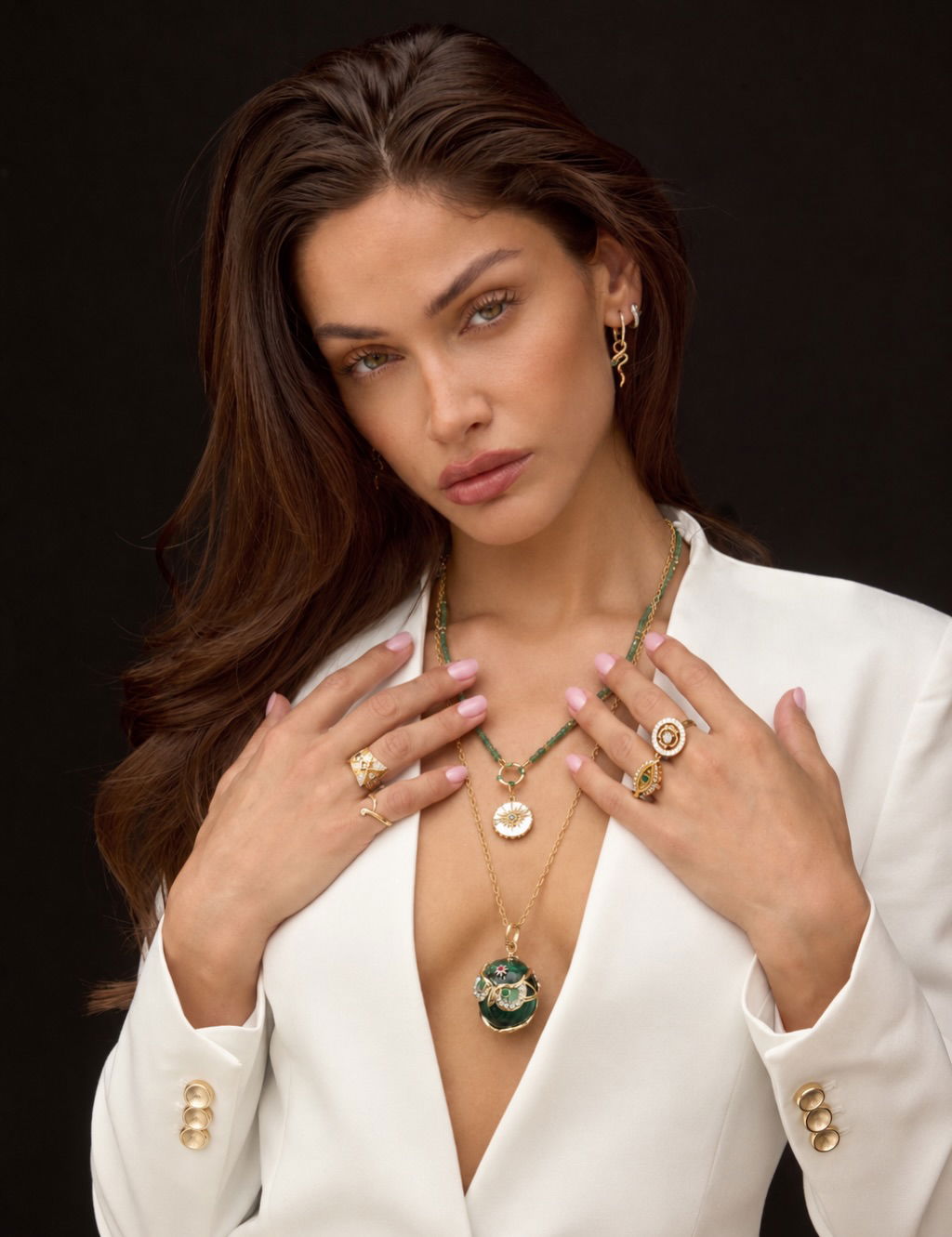 Three Stories necklaces and rings worn with a white blazer