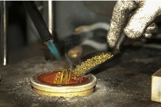 Jeweler crafting a custom piece in the Flawless Manufacturing workshop