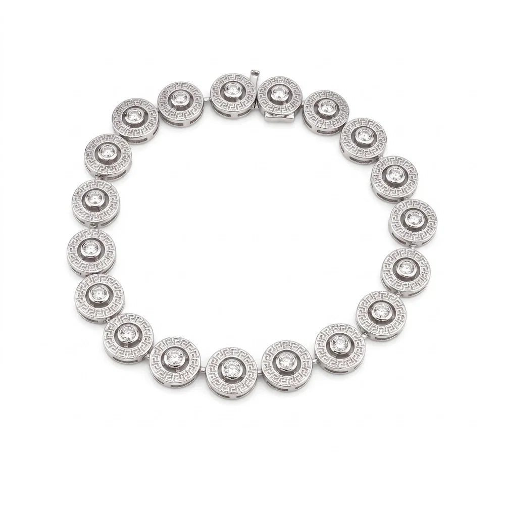 Fine gold bracelets arranged on a neutral background