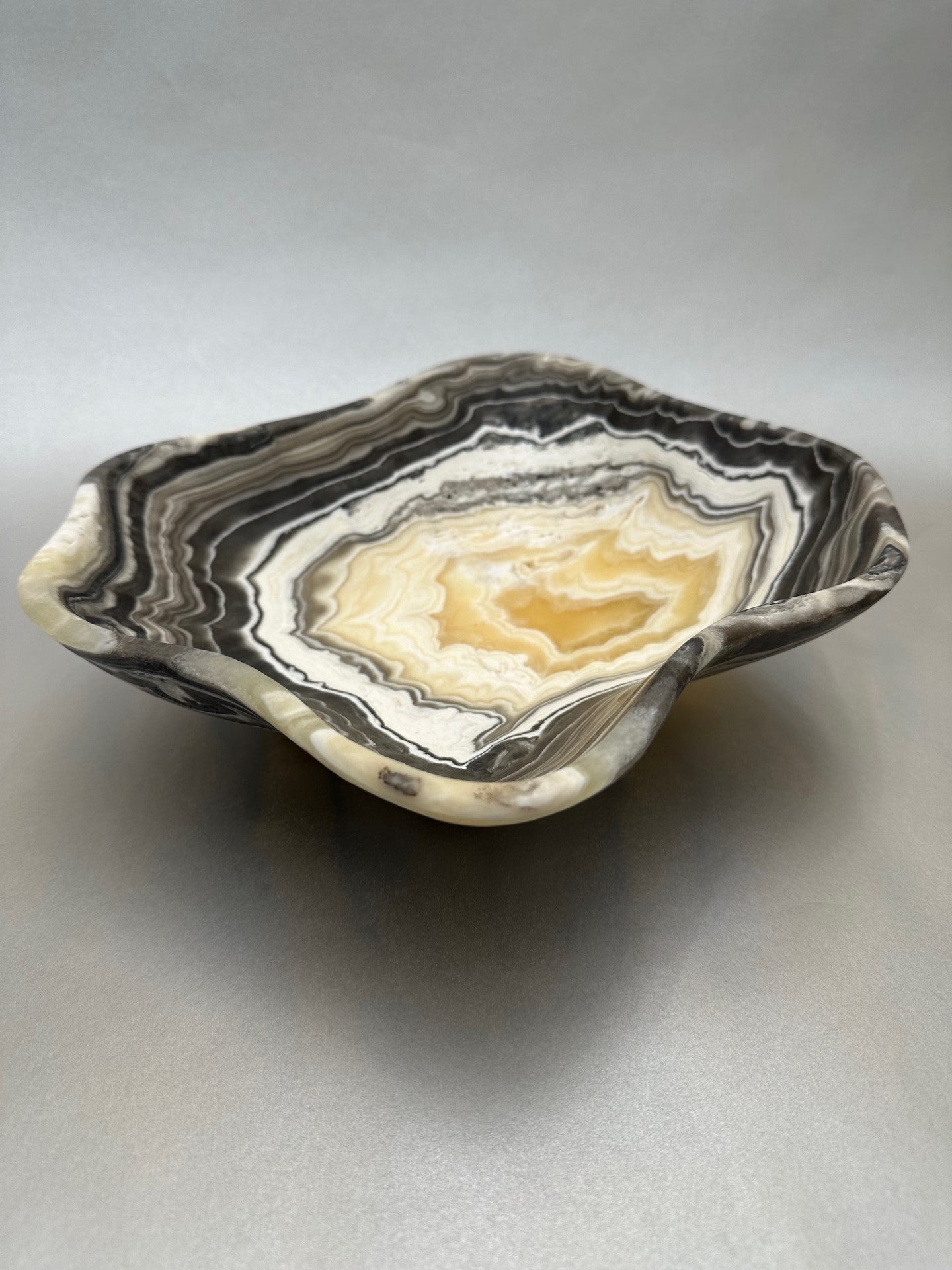 The 11" x 8.5" Free-Form Zebra Bowl is an exquisite statement piece, an eye-catching addition to any interior design. Whether serving your favorite snacks or adding a unique flair to your living space, this bowl is sure to ignite conversation with its bold, yet delicate curves. Free-Form Zebra Bowl