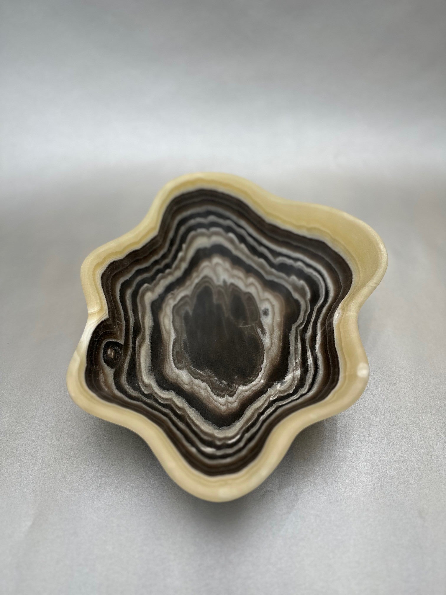 Crafted from the depths of the Earth, this Zebra Onyx Bowl is a unique, freeform masterpiece, measuring 10"x13". Dark Zebra Onyx Bowl