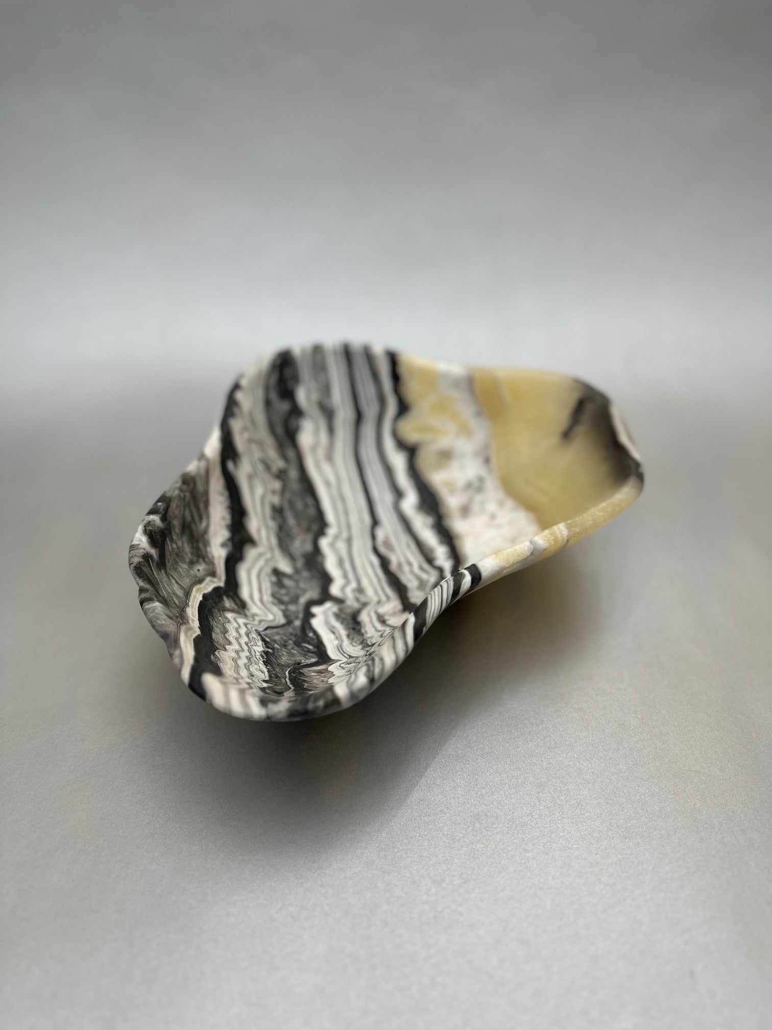 The 10" x 7.5" Free-Form Zebra Bowl is an exquisite statement piece, an eye-catching addition to any interior design. Whether serving your favorite snacks or adding a unique flair to your living space, this bowl is sure to ignite conversation with its bold, yet delicate curves. Free-Form Zebra Bowl