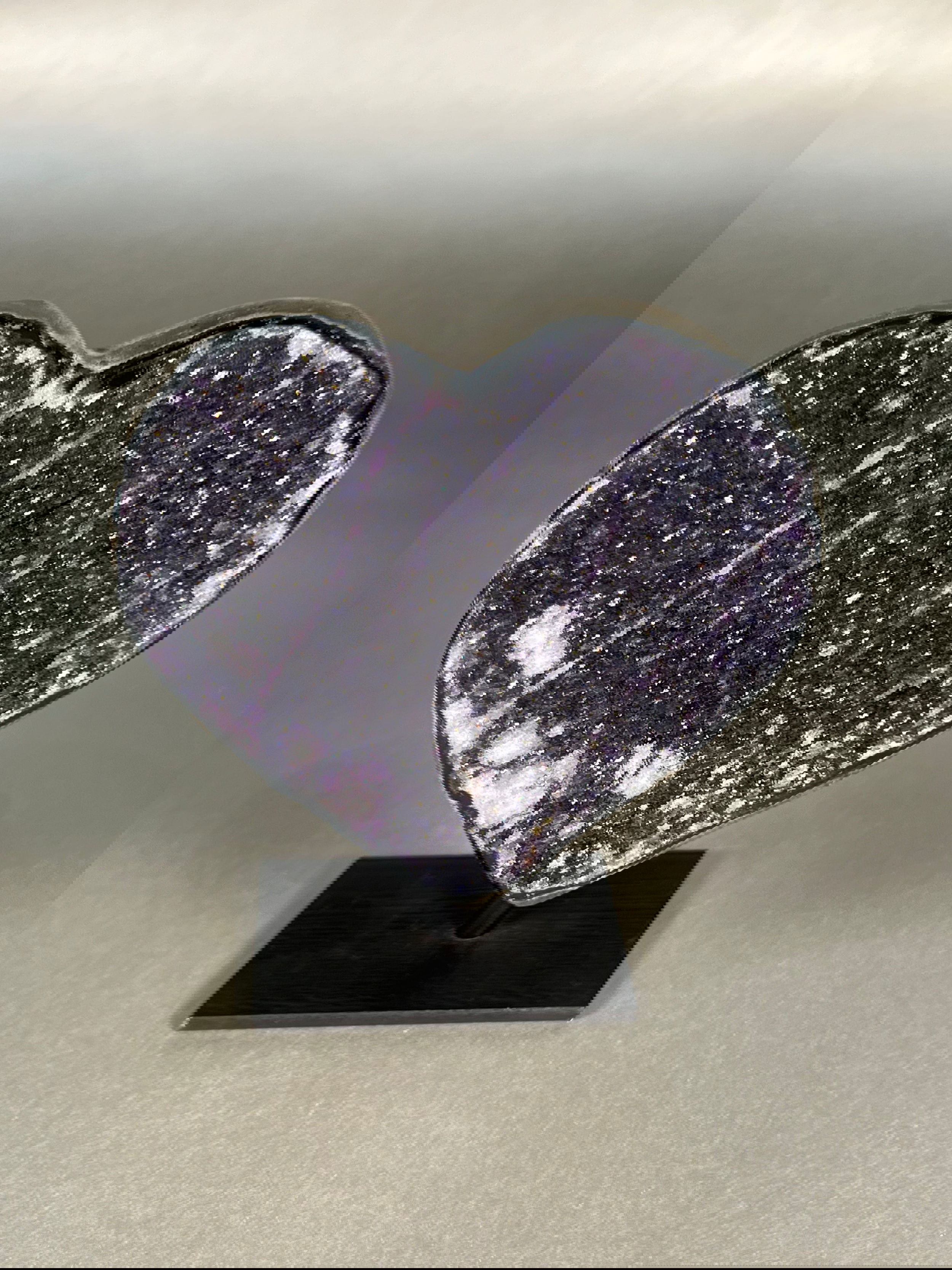 Indulge in the luxurious and exclusive beauty of our Amethyst Heart On Stand. With its unique color, this heart-shaped amethyst is a true masterpiece, resting elegantly on a stand. Approx. 4.5" x 5.5" Amethyst Heart On Stand