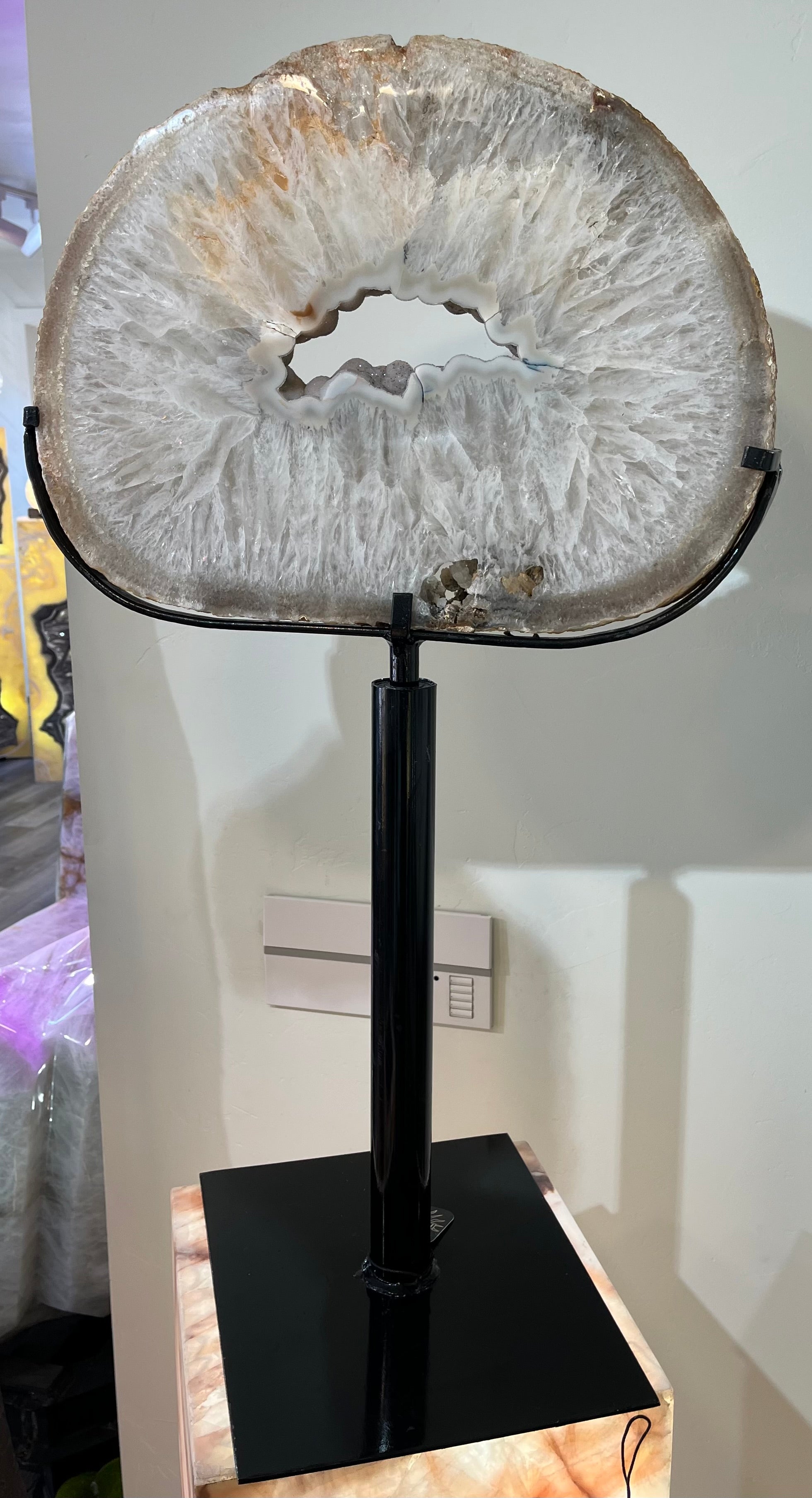 Indulge in the stunning beauty of our Brown Oyster Agate on Swivel Base. With its intricate sliced geode and elegant brown oyster agate, this piece is the epitome of luxury. The swivel stand allows you to admire its natural beauty from every angle. Bring a touch of sophistication and exclusivity to your space with this premium product. Measures approx. 18 1/2"W x 31 3/4"H (with stand). Brown Oyster Agate on Swivel Base
