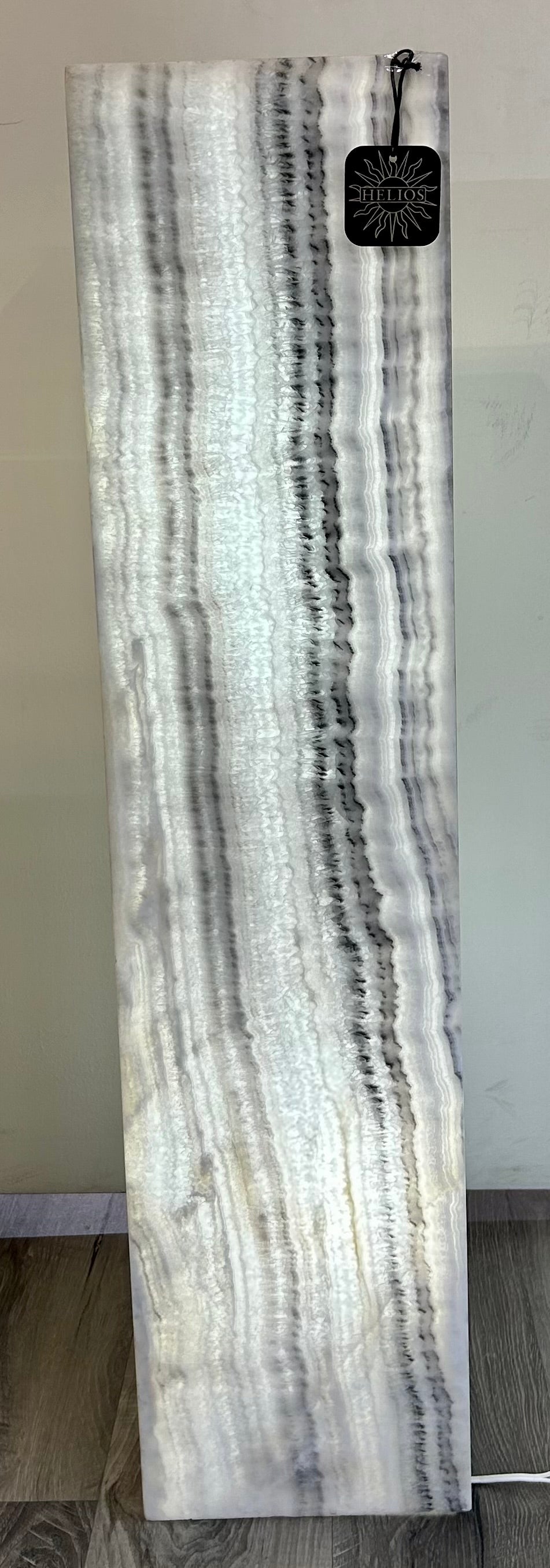 Elevate your home decor with our Zebra Onyx Lamp, crafted from luxurious, patterned zebra onyx. This distinctive piece will add a touch of sophistication to any room, creating a visual statement that is sure to impress. Experience the beauty and elegance of this rare natural stone in the form of a stunning lamp.Measures approx. 8"W x 33 1/4"H. Zebra Onyx Lamp