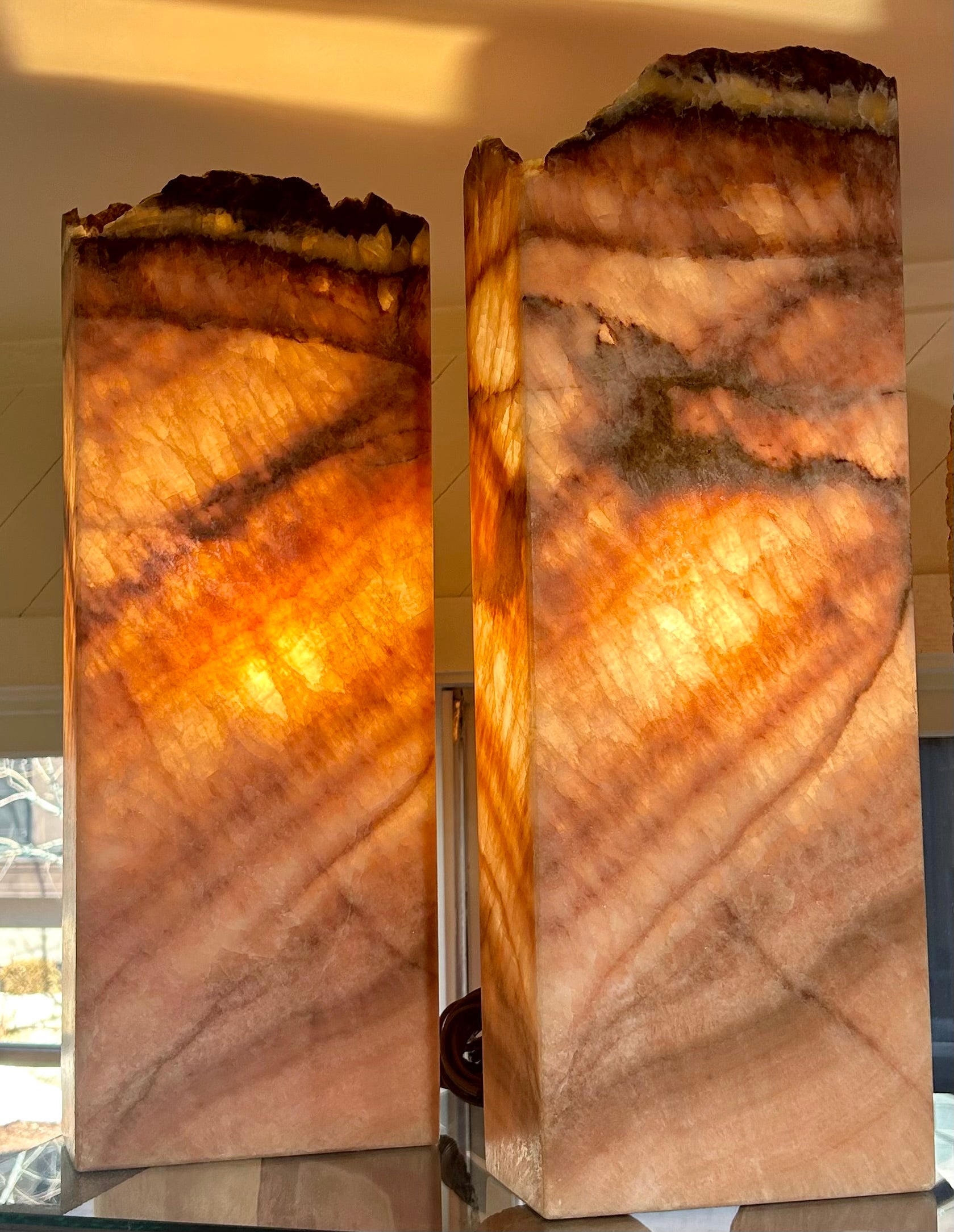 Experience luxury and sophistication with our Rose Onyx Lamp. Crafted from rare and exquisite rose onyx, this stand-alone lamp adds a touch of elegance to any space. Its unique design and soft lighting create a tranquil ambiance, making it the perfect addition to your home decor.Approx. 22" T x 8" Rose Onyx Lamp