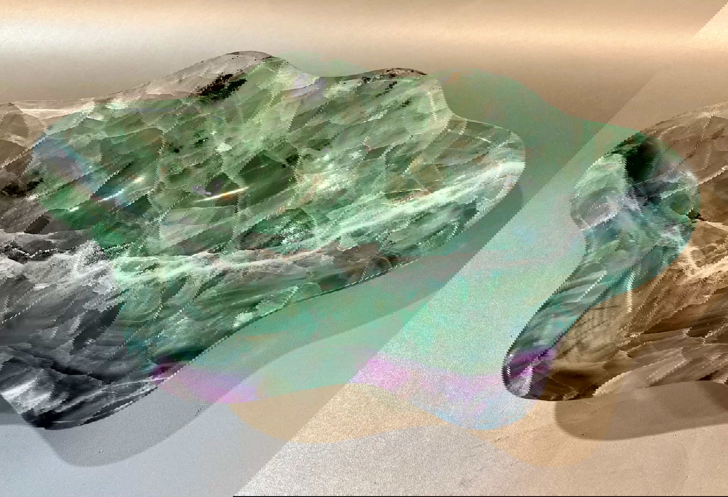 Indulge in luxury with our Banded Fluorite Bowl. Crafted from rare, high-vibration Fluorite, this bowl is more than just a decorative piece - it brings a sense of elegance and refinement to any space. Allow its energy to elevate your surroundings and enhance your days.Approx. 10 x 5 x 2 Banded Fluorite Bowl
