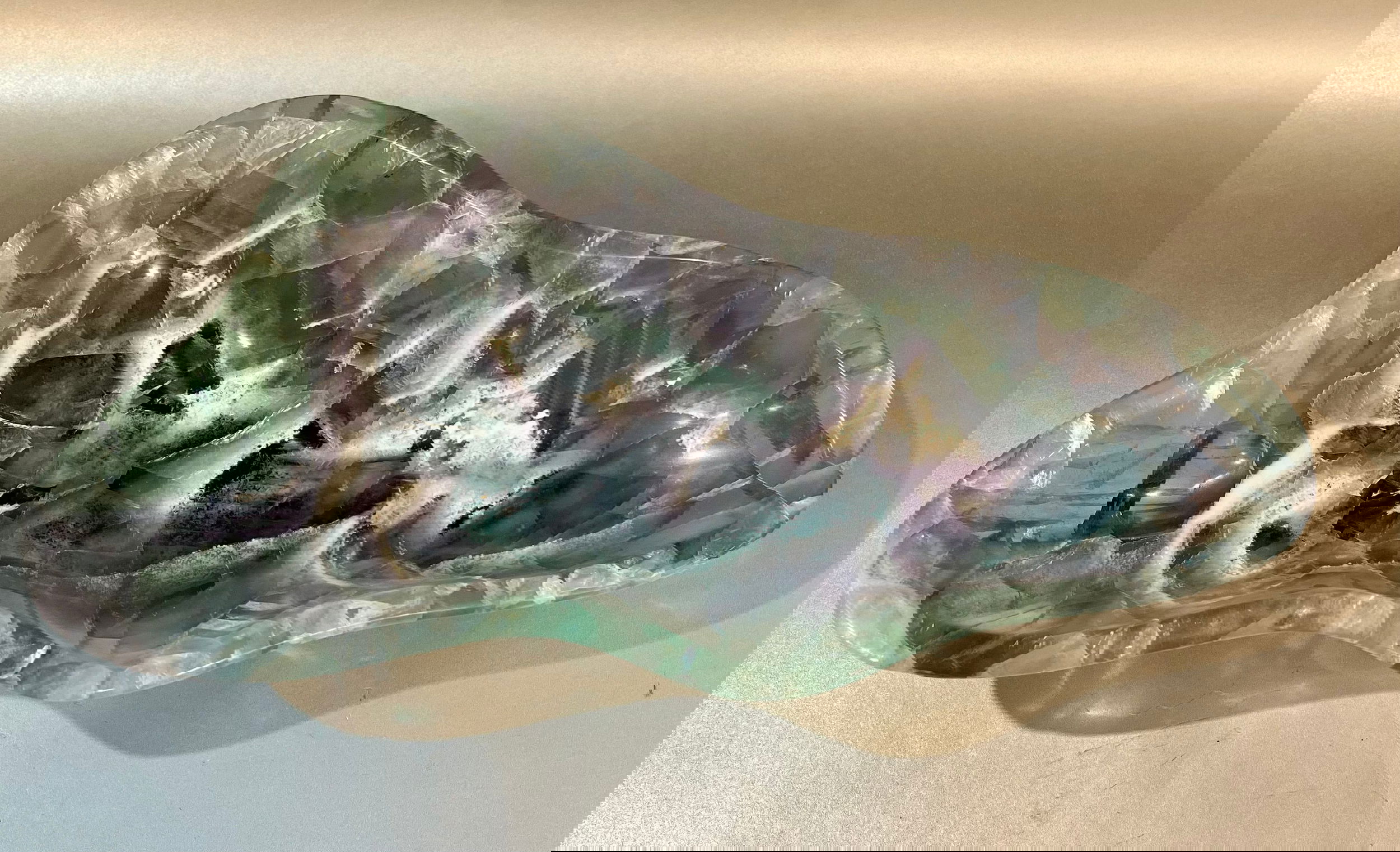 Indulge in luxury with our Banded Fluorite Bowl. Crafted from rare, high-vibration Fluorite, this bowl is more than just a decorative piece - it brings a sense of elegance and refinement to any space. Allow its energy to elevate your surroundings and enhance your days.Approx. 11 x 5 x 2 Banded Fluorite Bowl