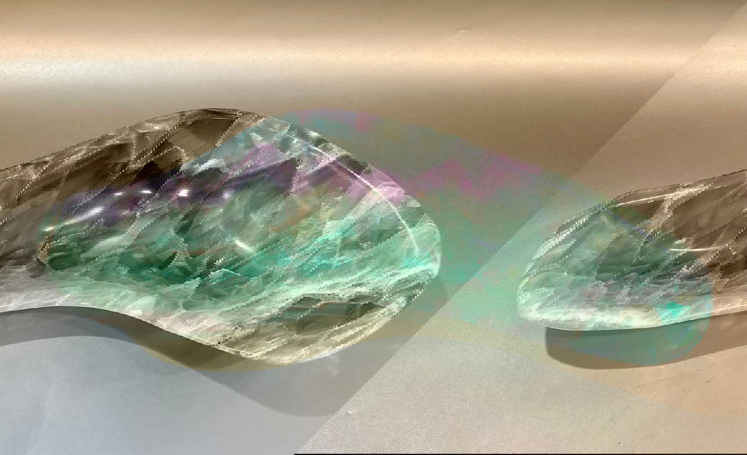 Indulge in luxury with our Banded Fluorite Bowl. Crafted from rare, high-vibration Fluorite, this bowl is more than just a decorative piece - it brings a sense of elegance and refinement to any space. Allow its energy to elevate your surroundings and enhance your days.Approx. 11.5 x 4 x 1.5 Banded Fluorite Bowl