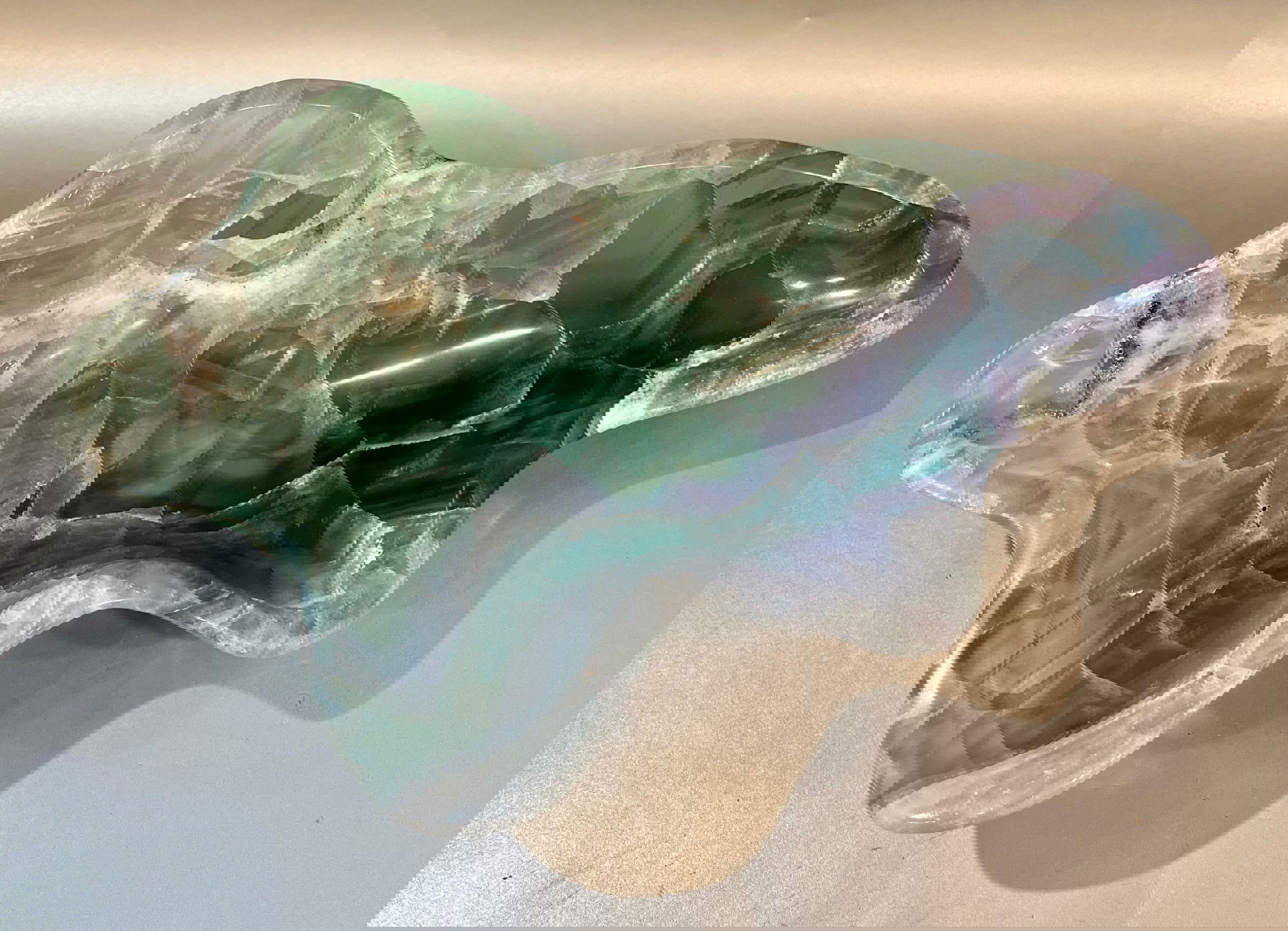 Indulge in luxury with our Banded Fluorite Bowl. Crafted from rare, high-vibration Fluorite, this bowl is more than just a decorative piece - it brings a sense of elegance and refinement to any space. Allow its energy to elevate your surroundings and enhance your days.Approx. 11 x 7 x 2.5 Banded Fluorite Bowl