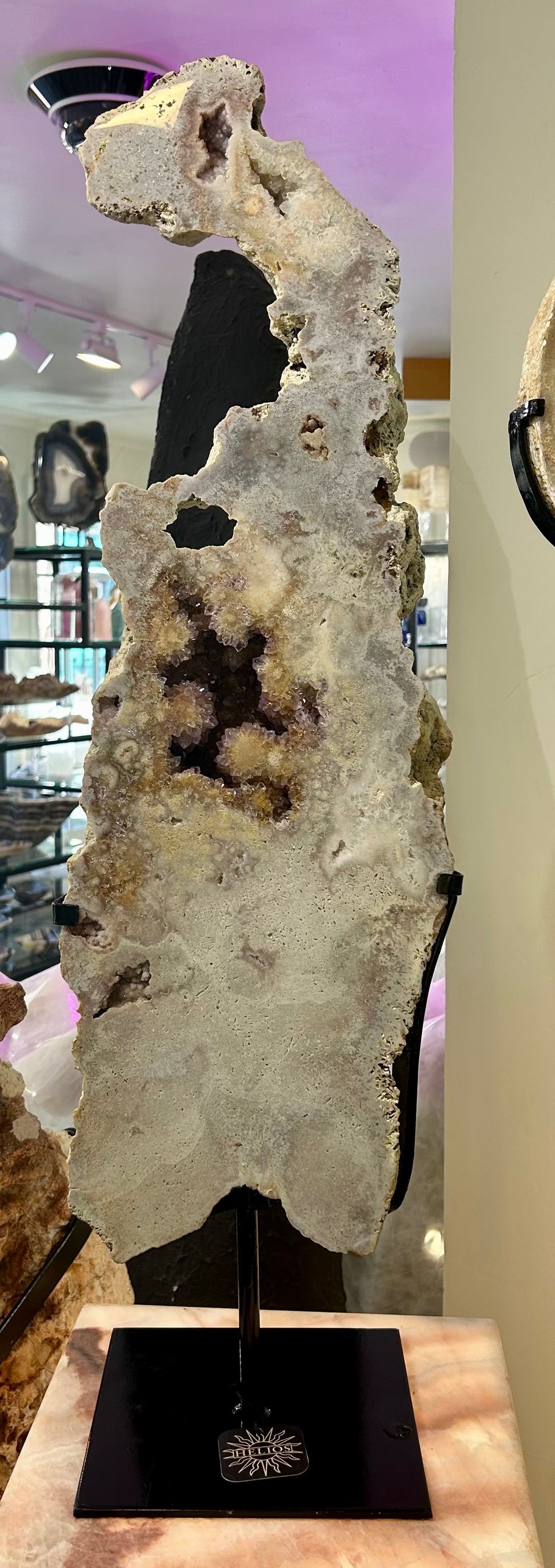 Elevate your space with our Freeform Pink Amethyst Slab. Its unique shape and stunning pink hue make it a stand-out piece. Display it on the included stand for a luxurious touch. Experience the beauty and elegance of nature in a whole new way. Freeform Pink Amethyst Slab