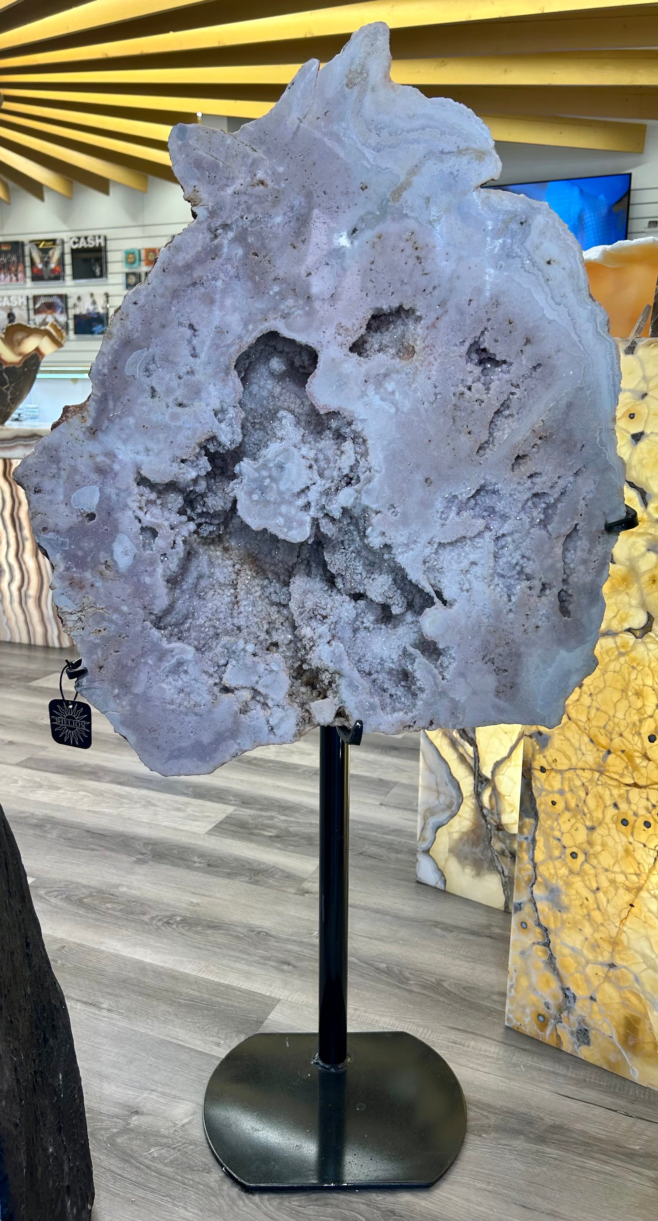 Indulge in the luxury and sophistication of our Large Pink Amethyst Boulder Slab. This stunning piece features a captivating pink amethyst, expertly cut into a sleek slab, elegantly presented on a stand. Unleash its potential to enhance any space with its opulent charm and unique beauty. Large Pink Amethyst Boulder Slab