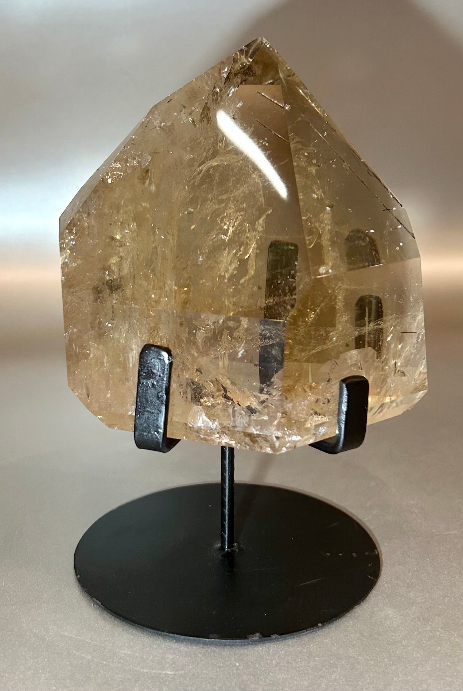 Elevate your space with our Dark Citrine Point on Stand. This unique piece effortlessly brings positive energy to any room while cleansing the atmosphere. Let the dark citrine radiate sophistication and elegance, creating a luxurious ambiance in your home.4.25" x 6.5" Dark Citrine Point on Stand