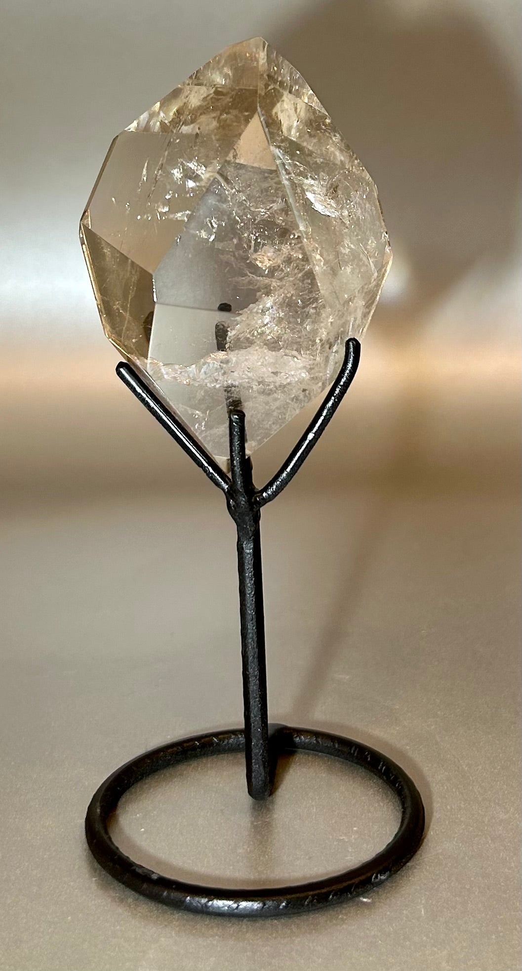 Make a statement with our rare Double Terminated Citrine on Stand. Not only is it a stunning conversation starter, but also a powerful energy cleanser. Add this elegant and exclusive piece to your collection and elevate your space with its sophisticated aura.2.25" x 6" Double Terminated Citrine on Stand