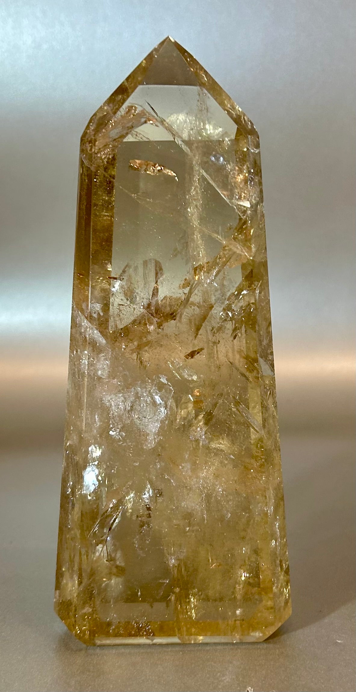 Embrace the rare elegance of this Citrine Point, a true gem in both decor and energy clearing. Its freestanding design allows for a unique display, while harnessing the powerful properties of Citrine. Add a touch of luxury to your space with this exclusive piece.Approx. 3" x 6.5" Citrine Point Free Standing