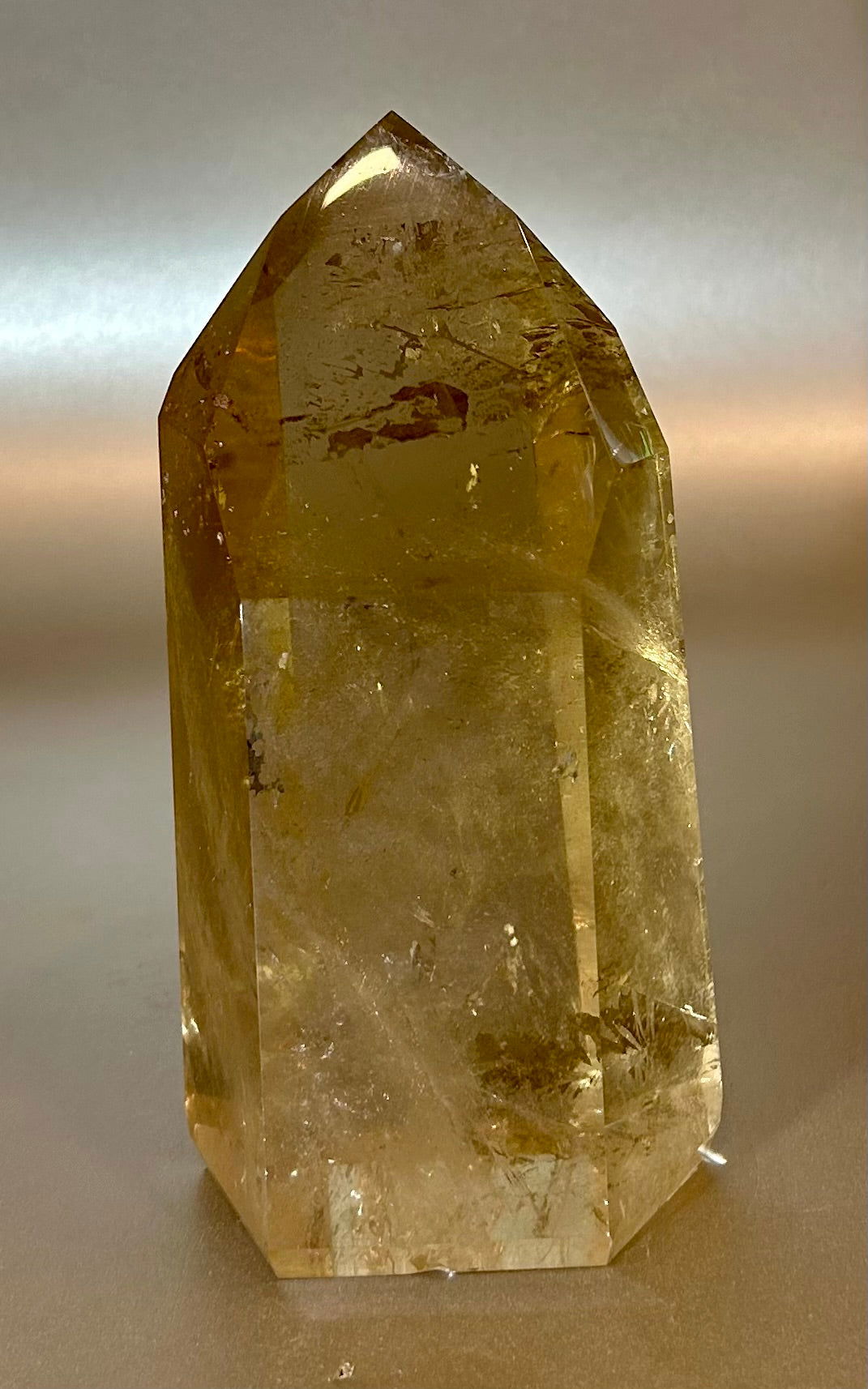 Embrace the rare elegance of this Citrine Point, a true gem in both decor and energy clearing. Its freestanding design allows for a unique display, while harnessing the powerful properties of Citrine. Add a touch of luxury to your space with this exclusive piece.Approx. 3" x 6" Citrine Point Free Standing
