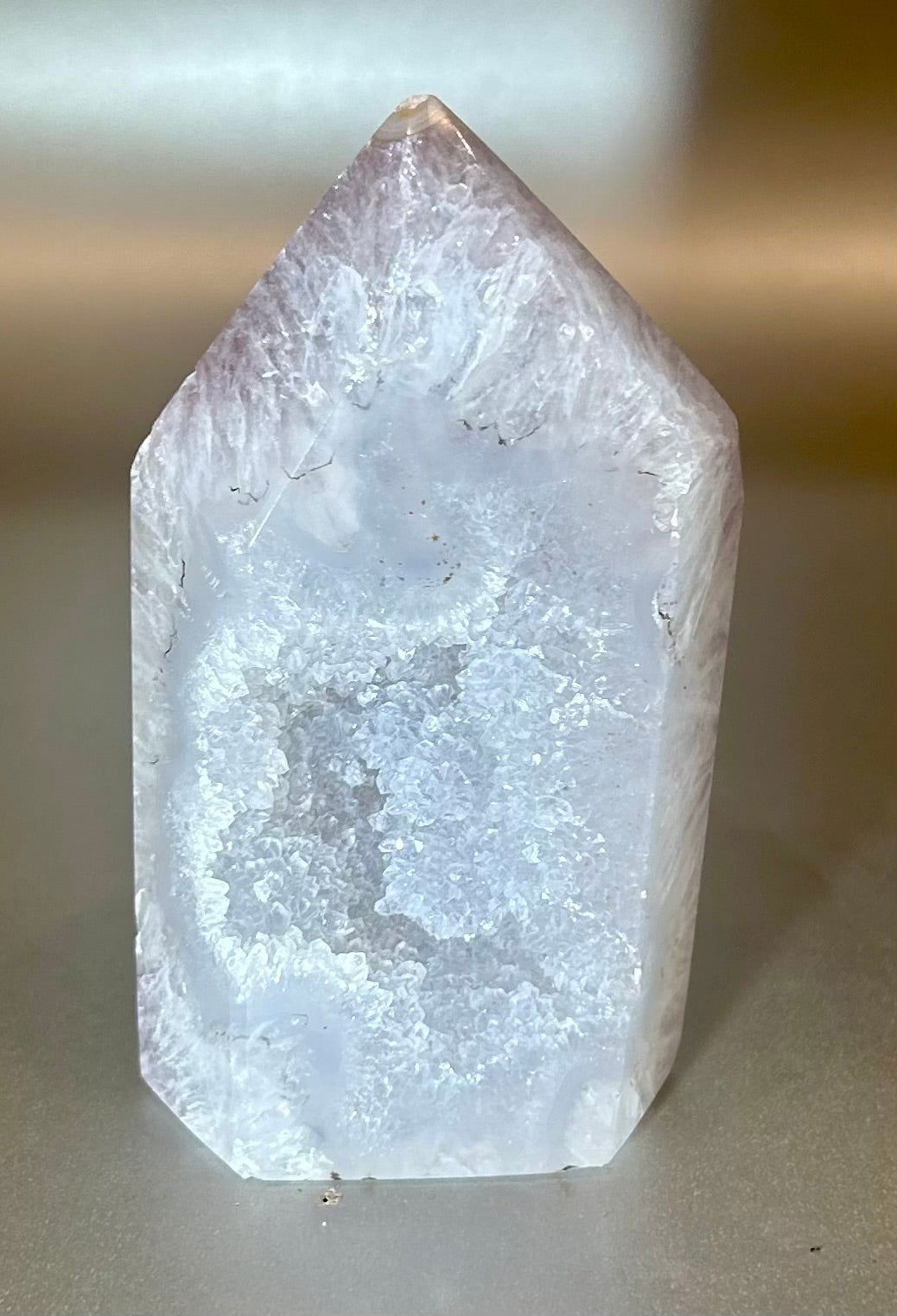 Add a touch of natural beauty to your decor with our polished agate geode point. Each piece is unique, showcasing stunning natural patterns. Display it to uplift your space and enhance your mineral collection.Approx. 2" x 4" Polished Agate Geode Point