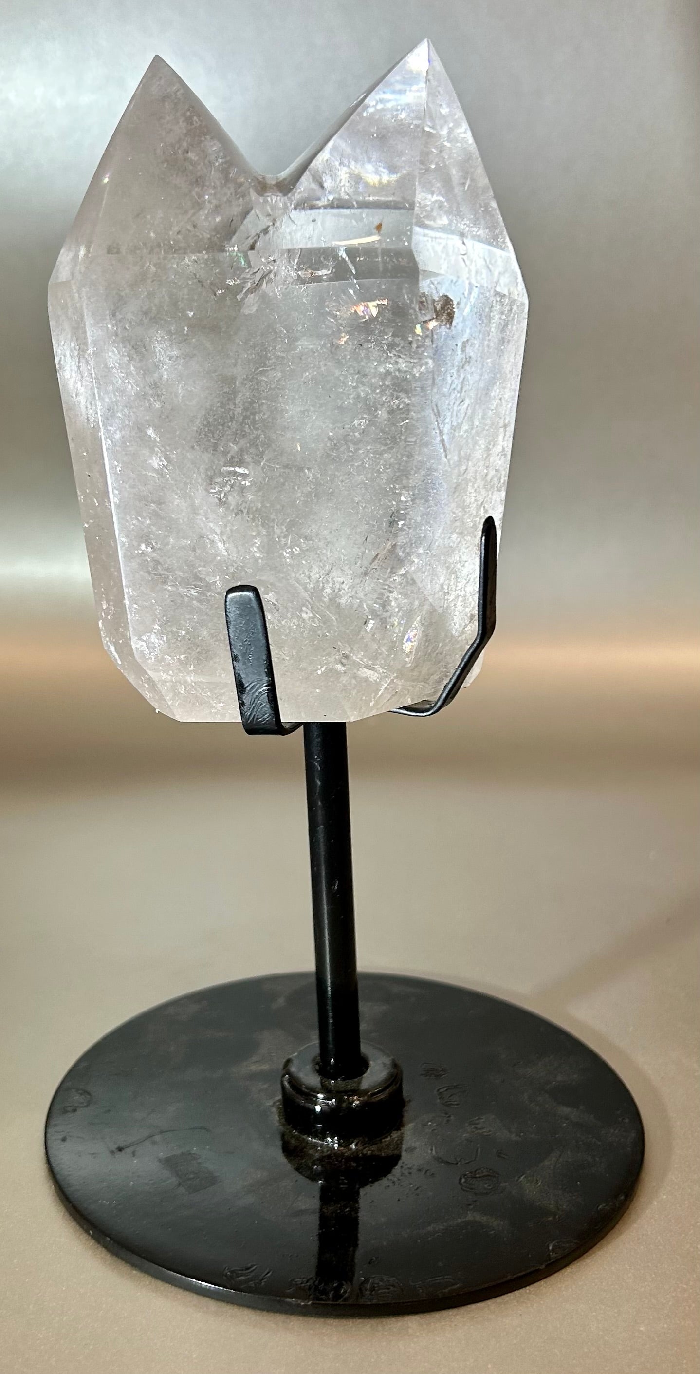 Embrace the essence of elegance with our Twin Crystal On Stand. This luxurious creation features two exquisite twin crystals, delicately placed on a swivel stand, allowing for versatile display options. Add a touch of sophistication to any space with this unique piece that exudes timeless beauty.Measures approx. 4.5"W x 8"H. Twin Crystal On Stand