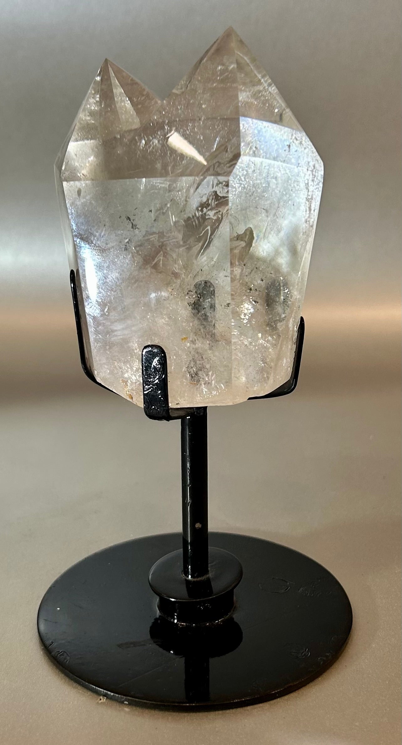 Embrace the essence of elegance with our Twin Crystal On Stand. This luxurious creation features two exquisite twin crystals, delicately placed on a swivel stand, allowing for versatile display options. Add a touch of sophistication to any space with this unique piece that exudes timeless beauty.Measures approx. 4"W x 7"H. Twin Crystal On Stand